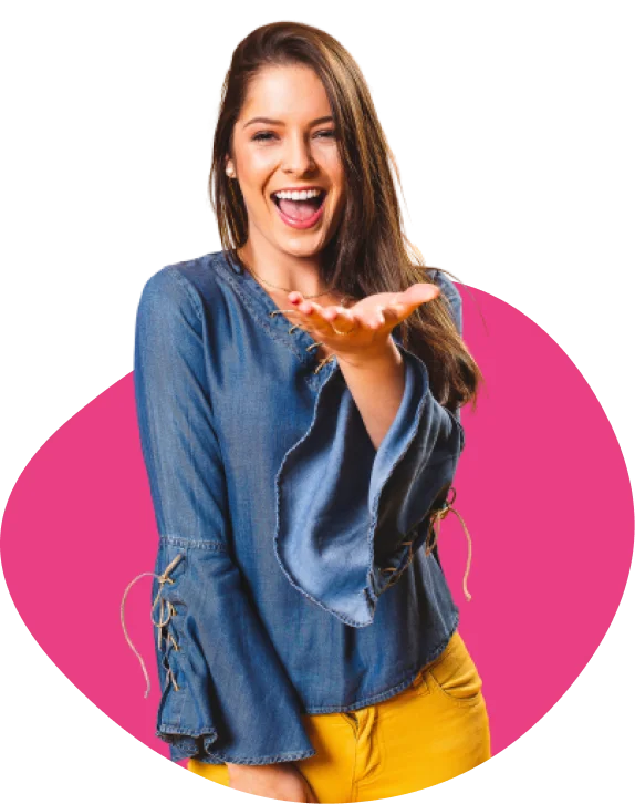 A woman in a blue blouse and yellow shorts, laughing and gesturing with one hand, stands against a pink circular background.